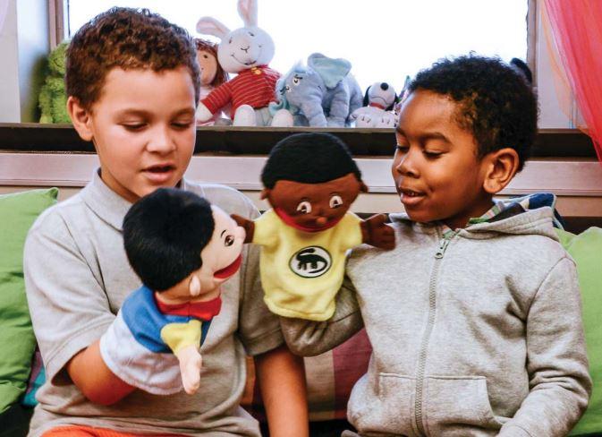 Boys playing with puppets