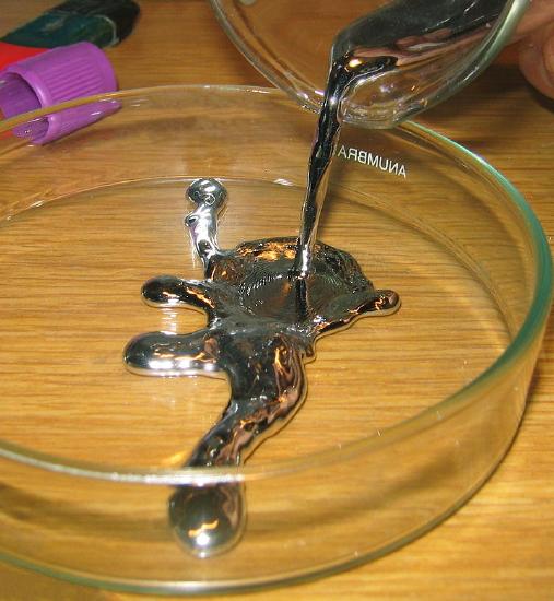 A jar is shown with a small amount of liquid mercury in it.
